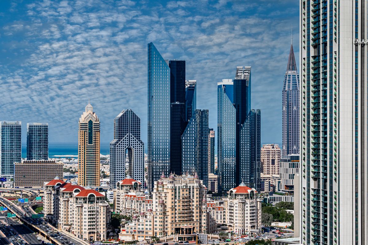 Dubai skyline with modern high-rise buildings under a blue sky