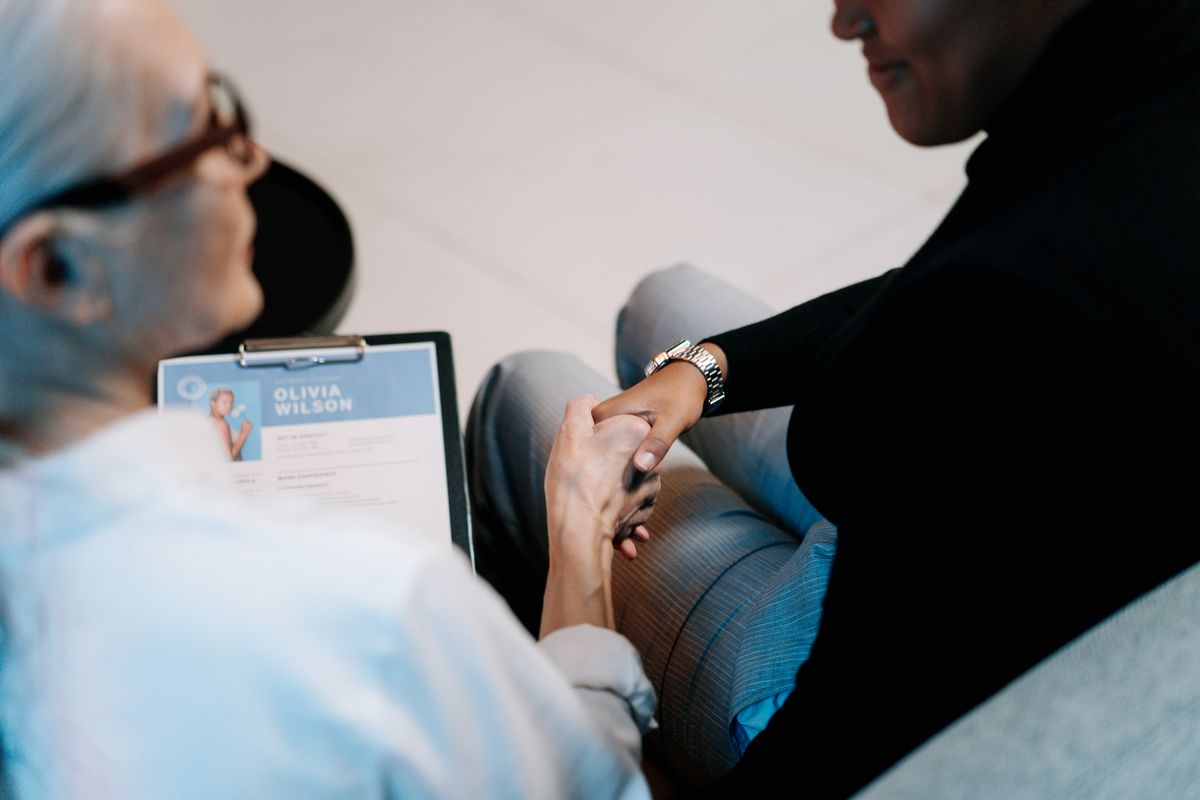 Two professionals shaking hands during a recruitment meeting