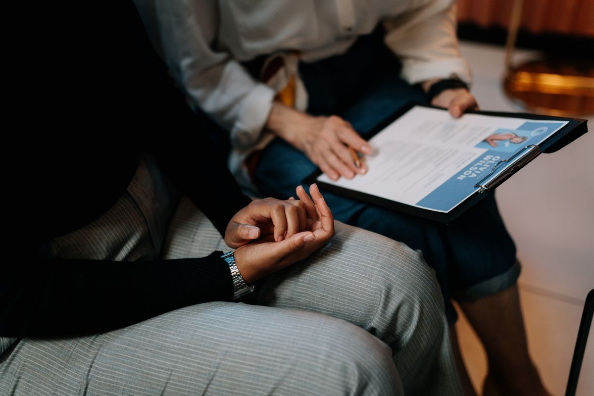 Professionals reviewing a printed resume during a recruitment meeting