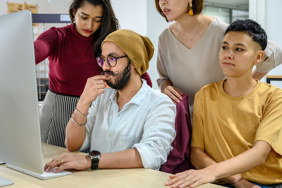 Colleagues sharing work and reviewing information at an office computer