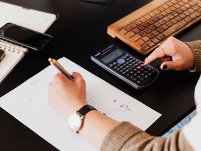 A bookkeeper checking figures with a calculator